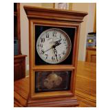 John Deere mantel clock featuring a vintage tractor design and the 'John Deere Moline' logo on the dial. 12 1/4' T x 7 1/4' W x 3 1)4' D.