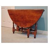 Vintage gateleg drop-leaf table, styled in the William and Mary tradition, oval top, chip see pic, one swing leg needs repaired see pic, great table though , 28 1/4' H x 48 1/2' L x 38 1/2' W.