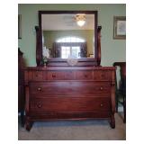 Antique 19th-century American Empire dresser features flamed mahogany wood and includes a detachable swivel mirror. With mirror 71' T, dresser 33' T x 48 1/4' W x 23'D. 3 upper drawers, 2 large lower 