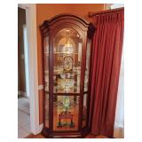 Corner Curio Cabinet Lighted Cherry, Mirrored back, beveled glass door, one light in top, 4 glass shelves with plate display grooves cut on back sides, MFG by Philip Reinisch Co., 78' T, 36' W, apprx.
