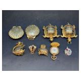 Grouping of vintage scarf clips, miniature pocket watch pendant (not working) and clock workings pendant