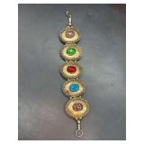 Vintage-style link bracelet featuring colorful glass cabochons in a gold-tone metal setting…..7” long