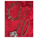 three necklaces, two choker style and one 15 inch with a dragonfly