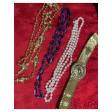 Three pieces of costume, jewelry, and a gold stretch belt