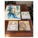Grouping of four religious themed canvases. 3 are 8“ x 8“ and the largest 16 x 20“