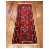 Red colored oriental rug in fair condition 30“ x 86“
