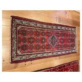 Red oriental rug in fair condition, missing fringe on one end. 33“ x 78“.