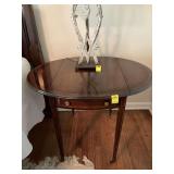 Baker Penbroke mahogany drop leaf side table on wheels. 19 1/2“ x 28“ x 27“ with the leaves dropped. Each rounded leaf is 8 1/2 inches wide.