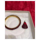 Polished necklace charm, and a bracelet