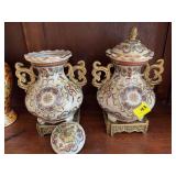12“ x 8“ handpainted ceramic lidded jar.  Set of 2, 1 handle has been repaired as shown in photos.