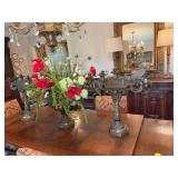 Three-piece brass set. Brass floral arrangement with poppies and two candelabras. The vase is 19“ x 13“ with arrangement it is 34“ x 38“. Candelabras are 23“ x 23“ without candles. Very he