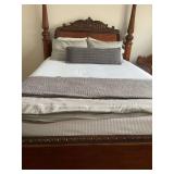 Grey queen size duvet cover with two matching shams, a knitted bed pillow, and grey queen size quilt.