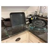 Two Pyrex  glass handled baking pans,a covered enamel roasting pan 12 inches and a 14 x 12 1/2”  enamel pan