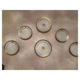 Set of six gold and black trimmed salad and dessert plates. 1 chip on bottom center plate as shown