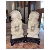 Pair of vintage intricately carved Chinese Foo Dog statues, also known as guardian lions - per seller, believed to be jade and each stands 6” tall including wood stand…..they are in their original