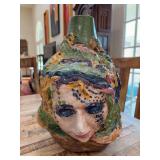 Ceramic vase featuring intricate, colorful, sculptural faces and textures……16” tall….there are markings on bottom (see pics)…..similar to the works of ceramicist Kirk Mangus