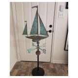 Vintage nautical weathervane featuring a copper sailboat design with a great looking patina, mounted on a black metal stand…..56” tall