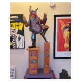 Fun, colorful, whimsical hand crafted wooden jester standing on 2 drawer units and displayed on wooden stand…..22 x 12-1/2 x 56 tall….details in the carving of jester are incredible