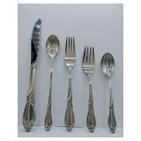 Sterling 'Rhapsody' flatware 5 piece place setting, knife, dinner fork, salad fork, dinner spoon, tea spoon. Weighs 162 grams. Introduced in 1957 by International Silver. The design features sweeping,