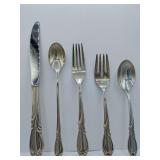 Sterling 'Rhapsody' flatware 5 piece place setting, knife, dinner fork, salad fork, dinner spoon, tea spoon. Weighs 162 grams. Introduced in 1957 by International Silver. The design features sweeping,