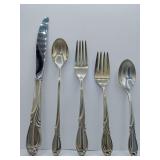Sterling 'Rhapsody' flatware 5 piece place setting, knife, dinner fork, salad fork, dinner spoon, tea spoon. Weighs 168 grams. Introduced in 1957 by International Silver. The design features sweeping,