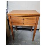 Sears Sewing machine cabinet no sewing machine. Measurements when opened are 48 x18 x 30.5 in tall. When closed cabinet is x18 x 30.5 in tall. Veneer bubble top lower left as shown.