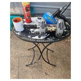 Miscellaneous grouping. Metal oval table, power XL ab roller, 25 ft drain cleaner with drill attachment, and more. See all photos