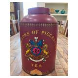 Vintage Jacksons of Piccadilly tea tin featuring the company's maroon branding, lion crest, and the Latin motto 'Utile Dulci” - 12-1/2” tall