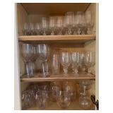 Contents of bar cabinet……glass stemware, plastic stemware and plastic wine glasses (bottom left and left on center shelf)