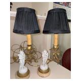 Pair of 19th-century French neoclassical-style table lamps featuring a porcelain putti figure on a marble base….right figurine has been repaired