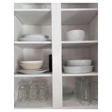 Contents of kitchen cabinet…..white serving pieces, clear glass