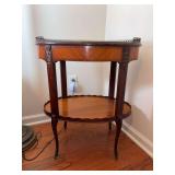 Vintage French Louis XV style oval marquetry side table, featuring two tiers, a brass gallery rail, and ormolu mounts…..23-1/2 x 15-1/2 x 28-1/2 tall….shows wear in places from normal use