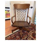 Vintage oak swivel office chair featuring a spindle back with decorative spheres and bentwood arms…..22-1/4 x 18 x 16-1/2 tall to seat (40” tall overall)