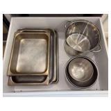 Contents of kitchen drawer - stock pot, various sizes knives mixing bowls, large cookie sheets, and serving pans