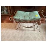Cast iron bench with a green and red feathered cushion 35“ x 15“ the cushion is 15 inches from the ground. The side handles are 18 inches from floor