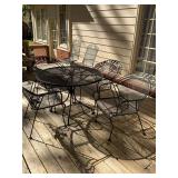 Black wrought iron patio set; table and four chairs.  The table is 42 inches round by 29 1/2 inches and the chairs are 28“ x 28“ x 33“.