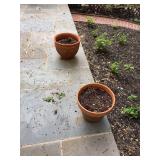 Two terra-cotta planters one is 12” x 11” the other is 14 1/2” x 11 1/2” a few nicks around top edging as shown