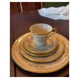 Lenox gold rimmed 5 Piece Pl. setting… pattern is Castle Garden.   Includes a 10 7/8 inch dinner plate, 8 inch salad plate, 6 1/2 inch dessert plate and a cup and saucer