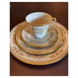 Lenox four piece gold trimmed China set. Includes 10 1/2 inch dinner plate, 8 inch salad plate and a cup and saucer.