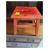 Wooden stepstool with carrying handle in center 13 in.² by 12 inches tall