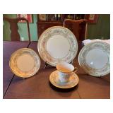 Lenox gold rimmed 5 Piece Pl. setting… pattern is Castle Garden.   Includes a 10 7/8 inch dinner plate, 8 inch salad plate, 6 1/2 inch dessert plate and a cup and saucer