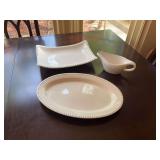 Three white serving pieces; the oval platter is 16 1/2“ x 11 the square platter is 14 1/2“ x 10 1/2“ in the gravy boat is 9“ x 4 1/2“