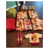 Grouping of fall napkins, rings, candles, and bottle cover