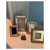 Multicolored perfume bottle and three small frames