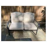 Hampton Bay patio bench with tan cushions 51“ x 31“ x 36“. The seat is 18 inches from ground. Has cover