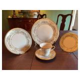 Lenox gold rimmed 5 Piece Pl. setting… pattern is Castle Garden.   Includes a 10 7/8 inch dinner plate, 8 inch salad plate, 6 1/2 inch dessert plate and a cup and saucer