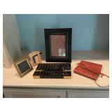 A vintage black and brass Abacus made in Hong Kong with a few picture frames and a leather CD holder