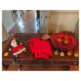 Grouping of Christmas tableware; 12 napkins, 9 chargers, six candle holders, salt and pepper shaker, bottle cover, etc.