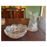 9 inch Crystal pitcher and a 8 1/2 inch Crystal bowl. The pitcher does have a crack across the bottom and a couple of chiggers on the bowl edges.
