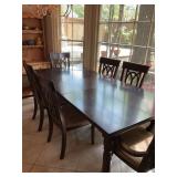Dining room table with six chairs. Two chairs are arm chairs.. table measures 88” x 42” with the leaf inserted. The leaf is 18 inches wide. Chairs are 21“ x 20“ x 41“. The chair seat is 18 1